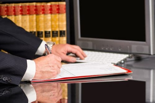 Man writing at a his office
