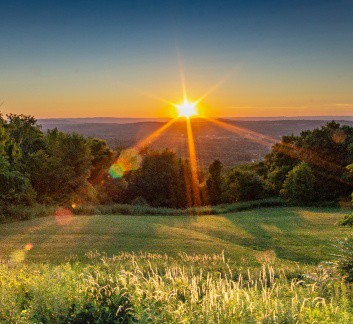 field view overlooking a sunset over the ocean