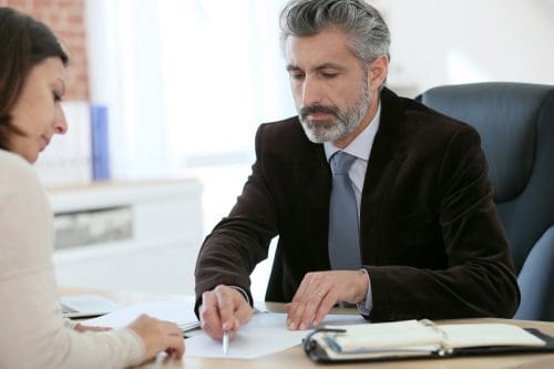 woman signing a paper