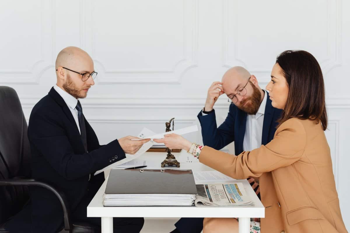 A Man Talking to Couple